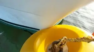 Yellow soft mooring buoy with bow impact